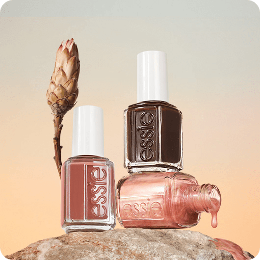 three bottles of boho rodeo polish on a rock with one on its side dripping polish