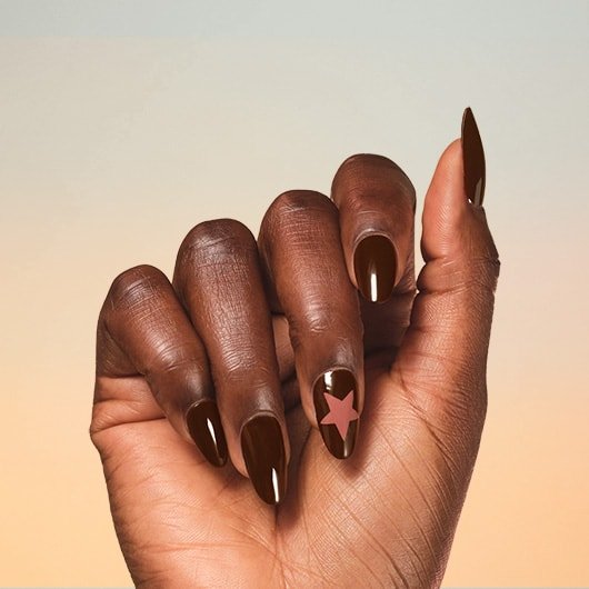 image of dark skin hand wearing a nail art using too hot to tame nail polish